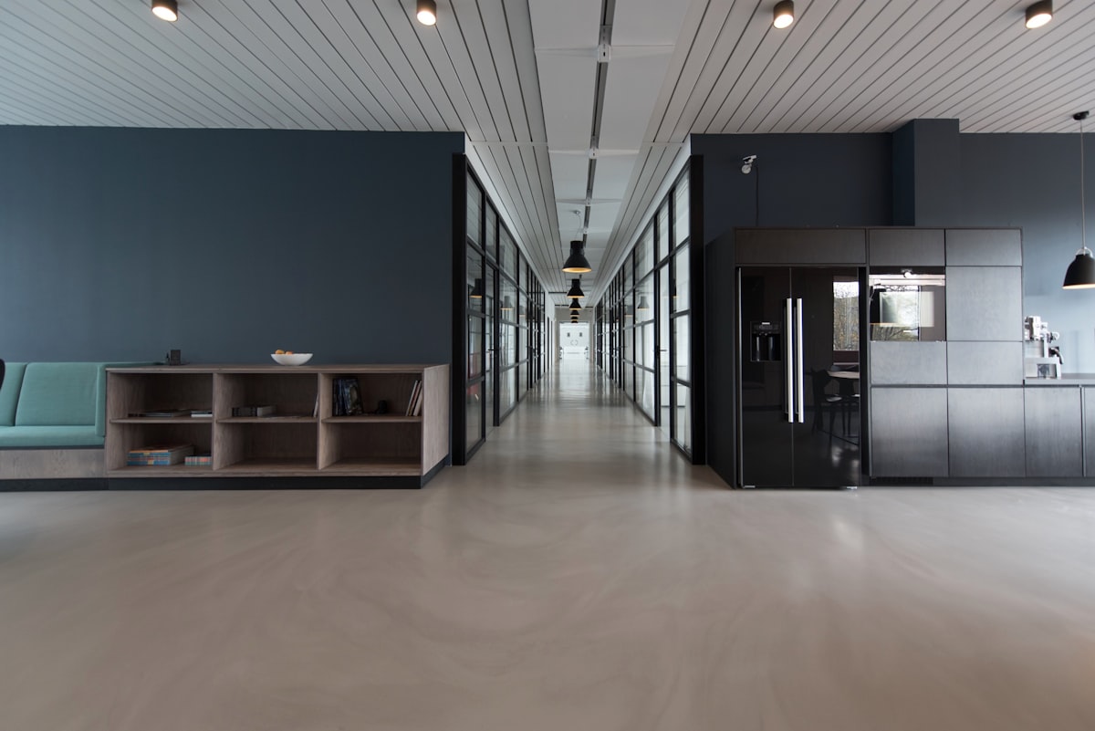 Shared studio desks with laptops where independent creatives work